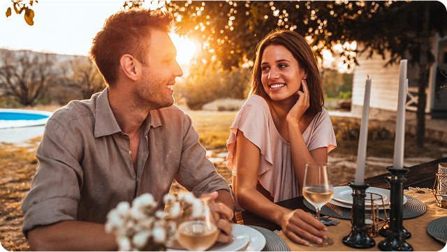 couple sitting at a sunset lit table