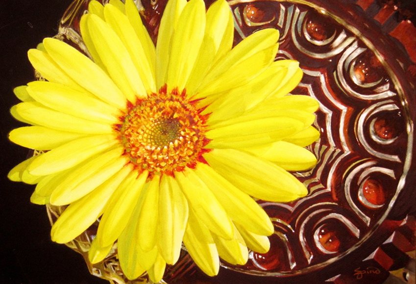 A large yellow flower in a painting.